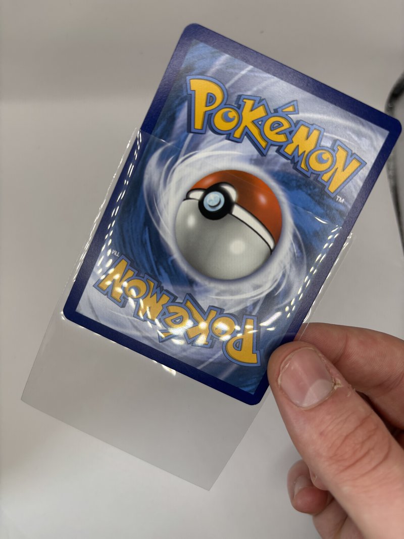 Card being placed into a penny sleeve